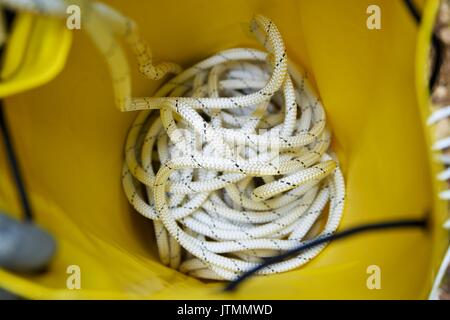 Climbing rope inside a yellow backpack. Stock Photo