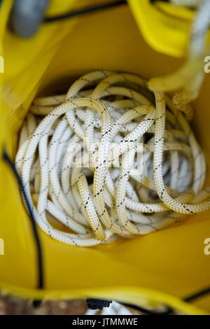 Climbing rope inside a yellow backpack. Stock Photo