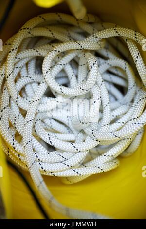 Climbing rope inside a yellow backpack. Stock Photo