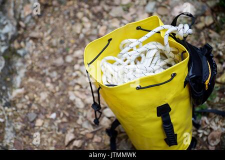 Climbing rope inside a yellow backpack. Stock Photo