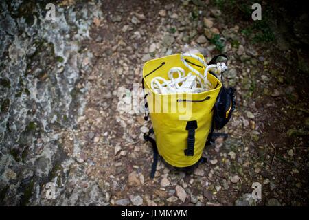 Climbing rope inside a yellow backpack. Stock Photo