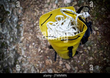 Climbing rope inside a yellow backpack. Stock Photo