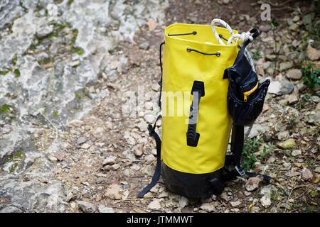 Climbing rope inside a yellow backpack. Stock Photo