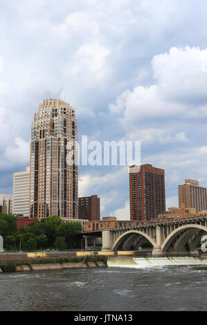 Minneapolis downtown skyline and Third Avenue Bridge above Saint Anthony Falls and Mississippi river, Midwest USA, state of Minnesota. Vertical compos Stock Photo