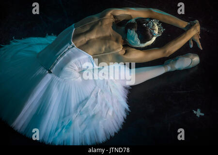 A prima ballerina in the role of 'Odette' in the scene of the ballet 'Swan Lake' performs at the theater stage in Moscow, Russia Stock Photo