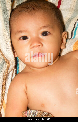 A baby boy portaiture with stripe towell background. Stock Photo