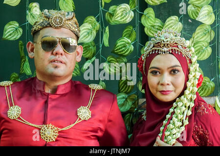 Traditional javanese wedding couple bride and bridegroom at garden Stock Photo