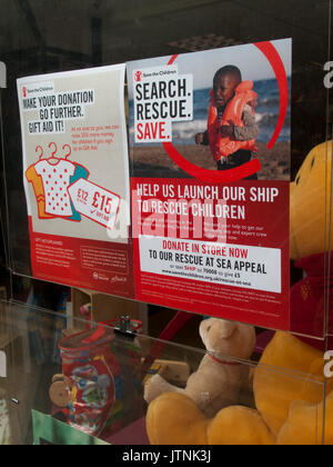 Save the Children poster in charity shop window, rescue refugee boat ...