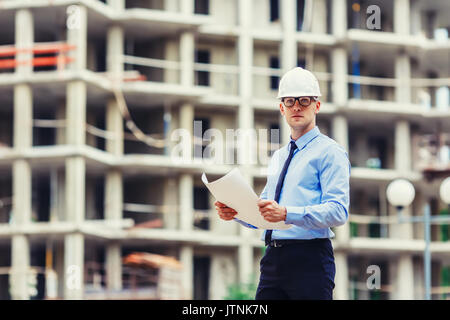 Handsom construction engineer at the construction site looking at the camera Stock Photo
