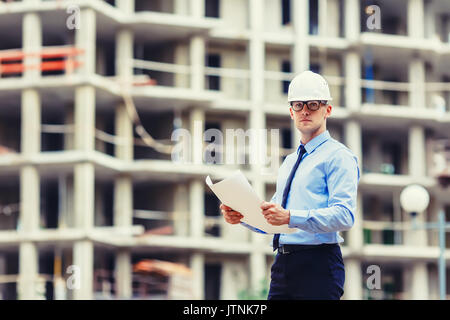 Handsom construction engineer at the construction site looking at the camera Stock Photo