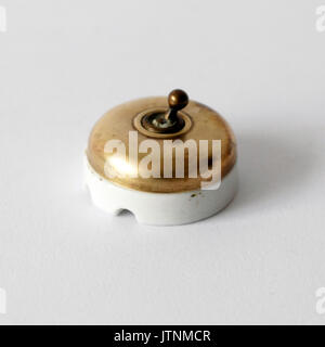 Vintage switch for electricity made by brass and porcelain Stock Photo