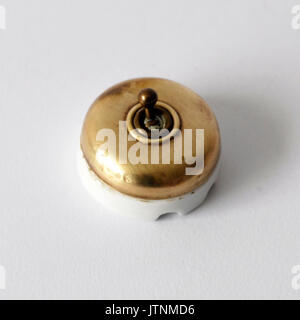 Vintage switch for electricity made by brass and porcelain Stock Photo