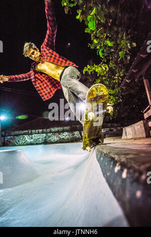 Skateboarder riding in skate pool, Jimbaran, Bali, Indonesia Stock Photo