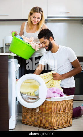The young husband man doing laundry at home Stock Photo - Alamy