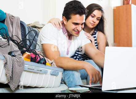 Happy couple preparing for honeymoon and making planning list Stock Photo