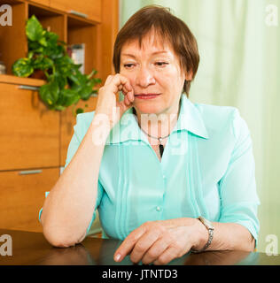 Portrait of sad senior woman having tough time   at home Stock Photo