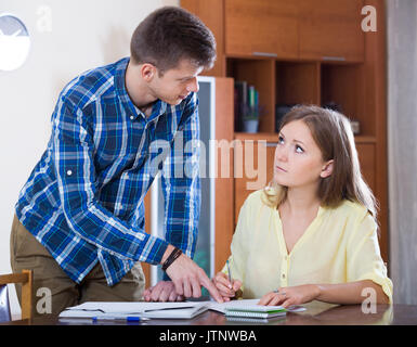 Two young european collegues working with documents together in office Stock Photo