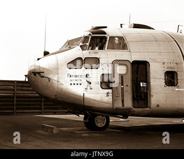 Left side view of a parked UC-123K Provider aircraft from the 315th Tactical Airlift Wing.  The aircraft, being inactivated, is named 'Patches' for the more than 1,000 hit-hole patches that it received during the Vietnam conflict.  The images painted on the aircraft are Snuffy Smith wearing a bullet-riddled hat and four Purple hearts, one for each aircrew member wounded in flight. Stock Photo