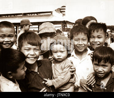 A new market for 'Tinh Thuong.'  Children gather before the market which was built with assistance from the government of Vietnam and USAID.  (USIA) EXACT DATE SHOT UNKNOWN NARA FILE #:  306-MVP-6-9 WAR & CONFLICT BOOK #:  409 Stock Photo