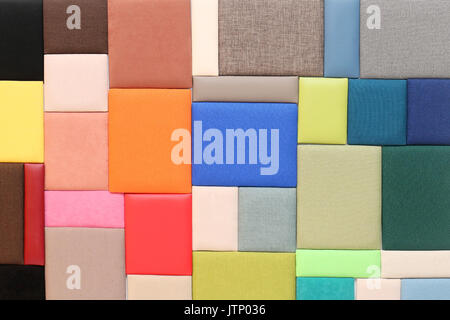 Bunch of upholstery materials textures samples on wall Stock Photo