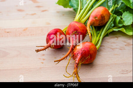 Orange beets on wooden table fresh from the garden Stock Photo