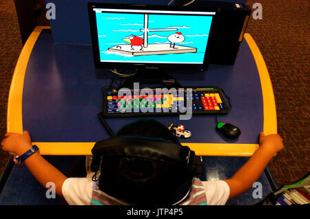 Watch Cartoon Using Computer Child watching cartoons on Ipad Stock Photo - Alamy