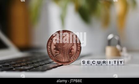 Digital currency physical metal bitcoin coin on the keyboard. Bitcoin security. Stock Photo
