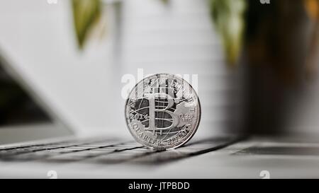 Digital currency physical metal bitcoin coin on the keyboard. Bitcoin security. Stock Photo