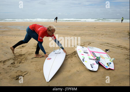 A surfer prepares to take part in the heats for the World Surf League Boardmasters Quicksilver Open competition at Fistral beach in Newquay, Cornwall. Stock Photo