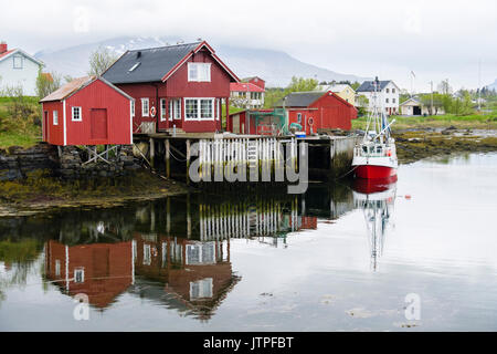 Fishing village with boats and wooden buildings on stilts. Nes, Vega Island, Norway, Scandinavia Stock Photo