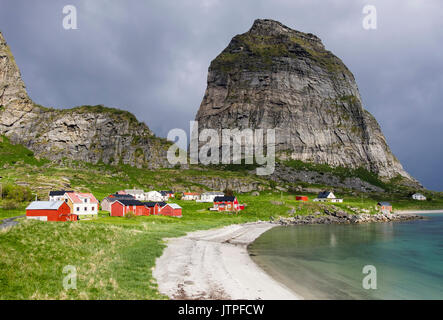 Old former fishing village houses around sandy beach below Trænstaven mountain on Sanna island, Træna, Nordland county, Norway, Scandinavia Stock Photo