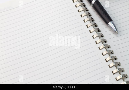 Close up view of note book with silver metal binder and pen with space for text - business background Stock Photo
