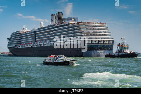 ms Oosterdam, Holland America Line -  Venice, Italy - 04 August, 2016: Cruise ship passing through the Grand Canal in Venice accompanied by a pilot bo Stock Photo