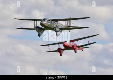 Two de Havilland Dragon Rapide biplanes flying together Old Warden Aerodrome Stock Photo