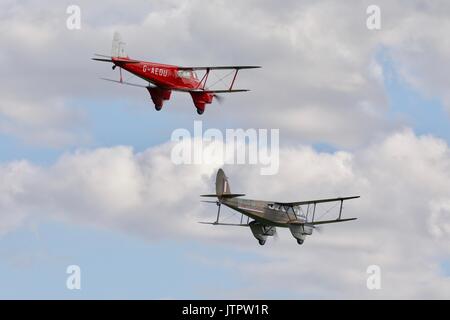 Two de Havilland Dragon Rapide biplanes flying together Old Warden Aerodrome Stock Photo