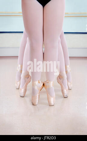 Three Pairs of Graceful Ballerina Legs in Pointe Shoes at the Dance Studio Class Stock Photo