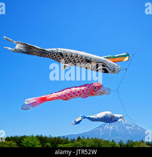 Colourful Koinobori Carp Kites against a clear blue sky at the Asagiri Highlands with Mt. Fuji in the background in Japan Stock Photo