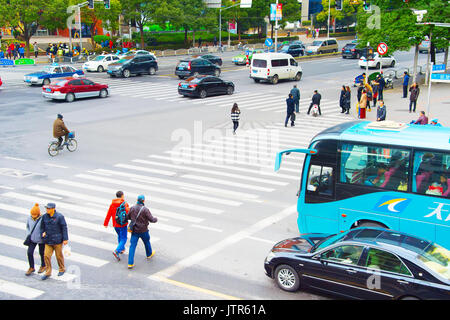 SHANGHAI, CHINA - DEC 28, 2016: People crossing the crosswalk at Shanghai Downtown Stock Photo