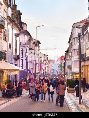 PORTO, PORTUGAL - NOV 27, 2016: People walking on Rua Santa Catarina at twilight. Santa Catarina is a main shopping street of Porto. Stock Photo
