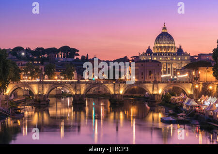 View of a stunning sunset setting behind the Vatican City from Ponte Umberto I, Rome, Italy