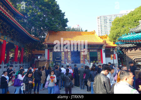 HONG KONG, CHINA - JANUARY 22, 2017: Crowd of people burning incenses inside of Wong Tai Sin Buddhist Temple to pray, in Hong Kong, China Stock Photo