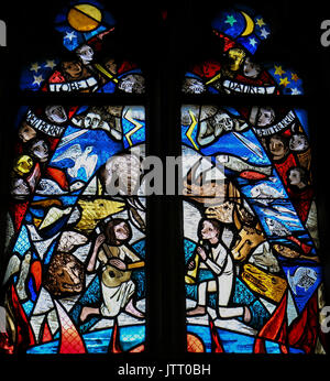 Stained Glass in the Stiftskirche Church in Tubingen, depicting Creation, with birds, fish, mammals en two children playing music Stock Photo