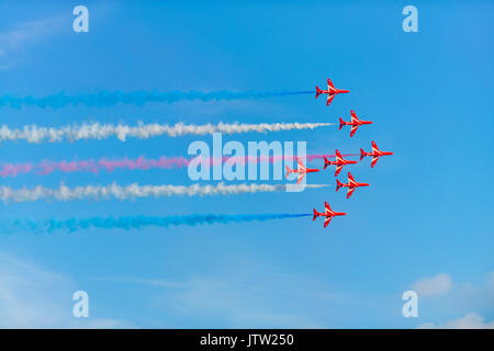 **Lyme Regis, Dorset, UK. 10th Aug 2017. The RAF Red arrows dazzle crowds with their low precision flying air show over Lyme Regis at the annual Regatta & Carnival Week in West Dorset on a warm sunny evening. Credit: Dan Tucker/Alamy Live News