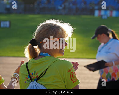 Sheffield, UK. 10th August, 2017. A volunteer and an official enjoy the sunshine at the Special Olympics National Games in Sheffield after a downpour dampened spirits at the opening ceremony Credit: Steve Holroyd/Alamy Live News Stock Photo