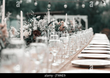 Glasses on the festive table setting. Wedding table decor concept. Table setting in classic style, setout. fine art. Stock Photo