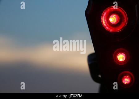 Bicycle Tail Light in Front of Sunset Stock Photo