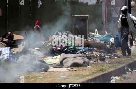 Locals sorting through rubbish that has been illegally dumped next to the road in Johannesburg Stock Photo