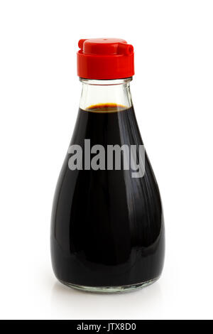 Glass bottle of soya sauce with red plastic lid isolated on white. Stock Photo