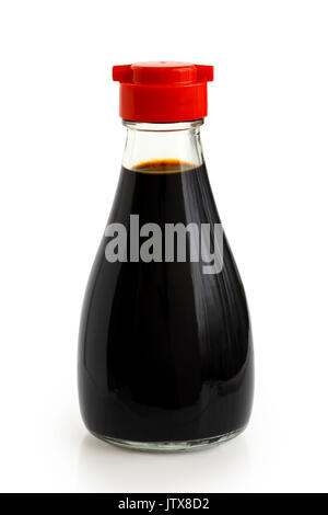 Glass bottle of soya sauce with red plastic lid isolated on white. Stock Photo