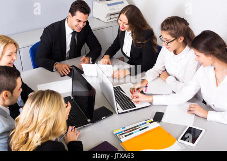 Cheerful business members of the multinational meetings at work in office. Focus on the right women Stock Photo